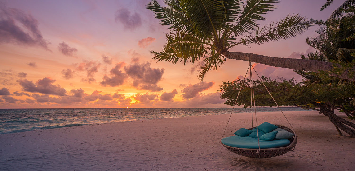 swing chair on a sunset lit beach